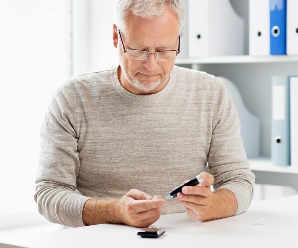 A man checks his blood sugar level