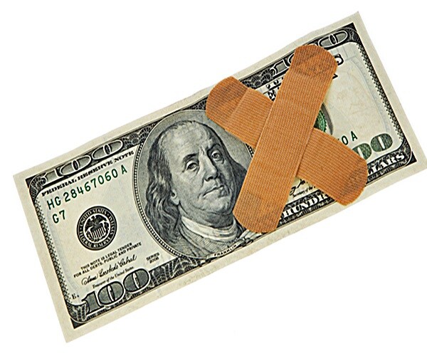100 dollars and medical plaster on white background.