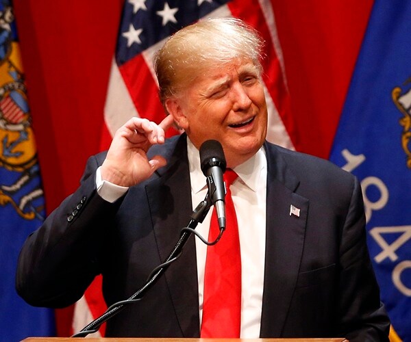 trump with his hand to his ear