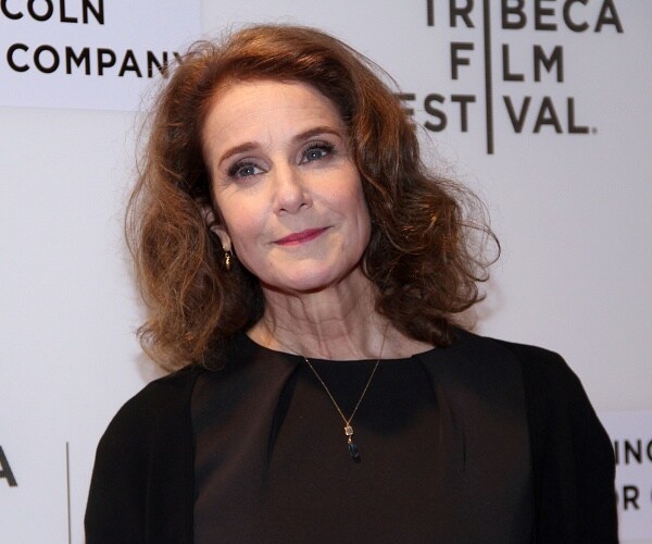 debra winger stands on red carpet