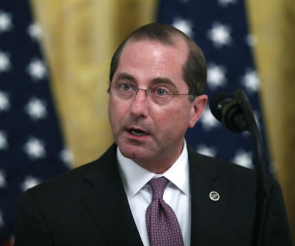 Health and Human Services Secretary Alex Azar is shown with the us flag in the background