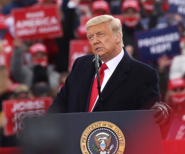 donald trump stands behind podium
