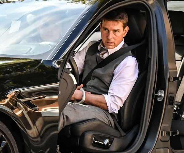 tom cruise sits in car missing drivers side door while fiming