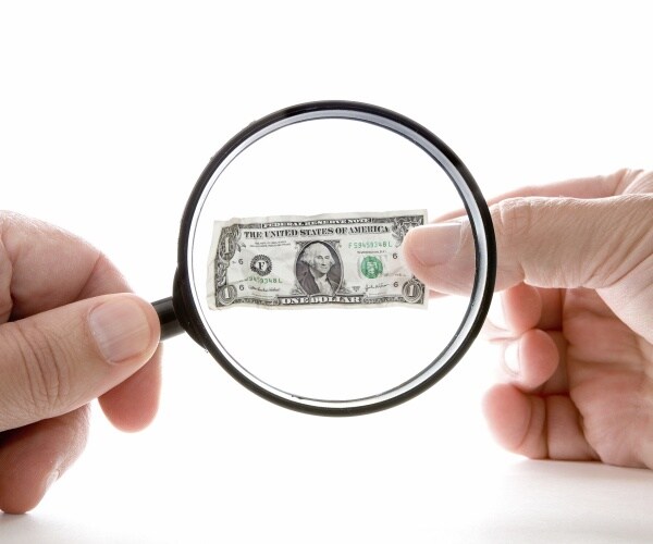 inflation shrinking value of us dollar under magnifying glass