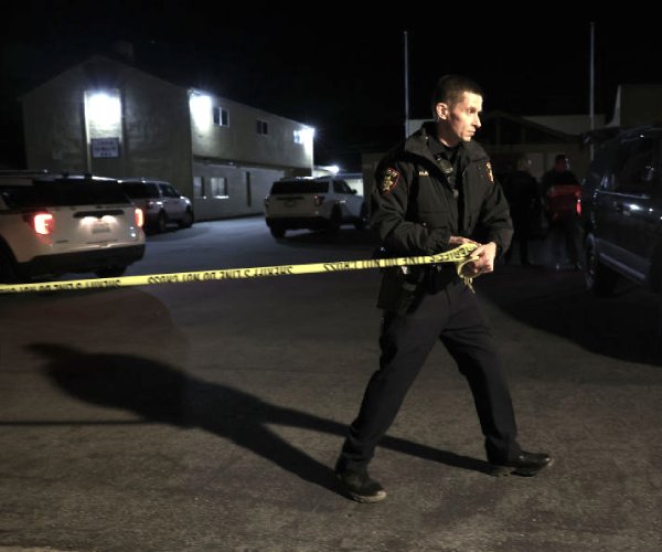 an officer works the scene of a shooting