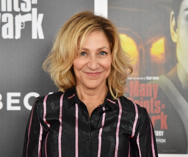 edie falco stands on red carpet