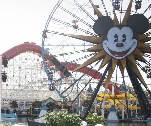 a ferris wheel with mickey mouse on the side at disneyland