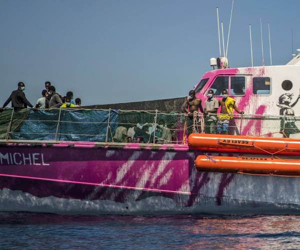 people standing on the deck of a boat
