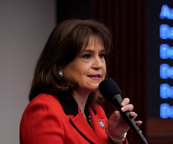 annette taddeo speaks into handheld mic