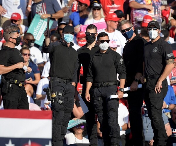 secret service agents stand outside at campaign rally
