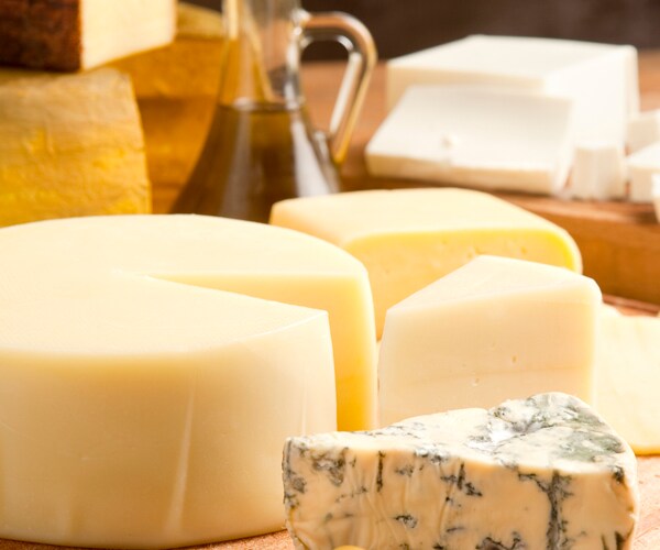 A board with cheese and olive oil