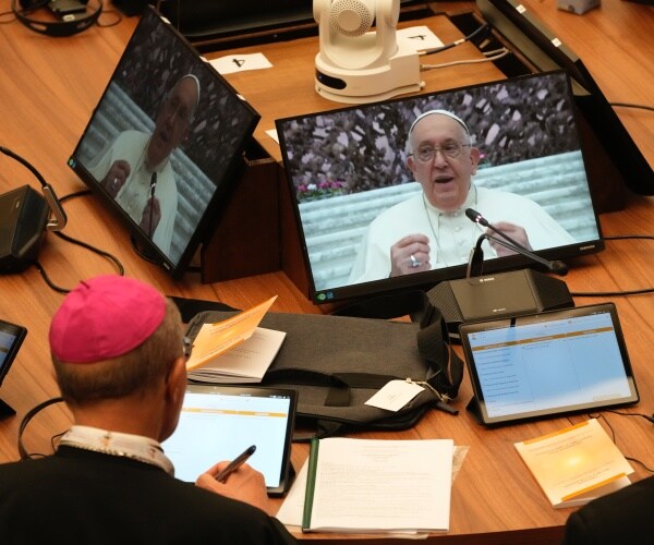 church leaders at the synod of biships follow pope francis on monitors