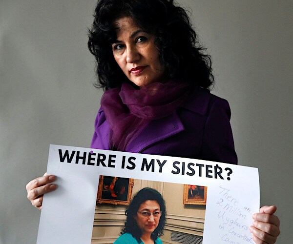 Rushan Abbas, 51, holds a photo of her sister Gulshan Abbas