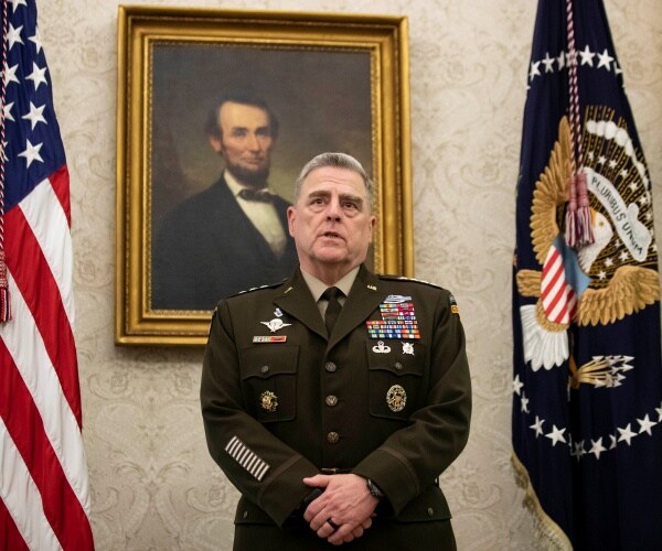 Milley in uniform next to a us flag and standing in front of a portrait of lincoln