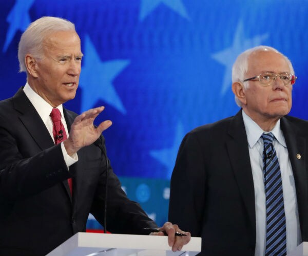 former vice president joe biden and sen. berie sanders are shown in a democratic primary debate