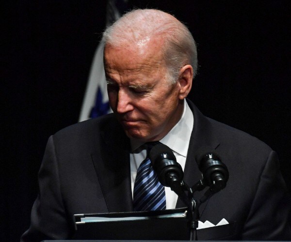 biden looks down as he speaks