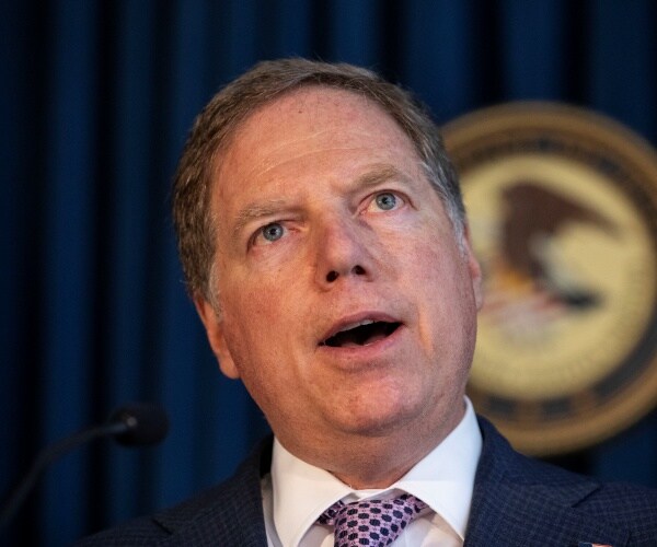 berman in a navy blue suit and purple tie