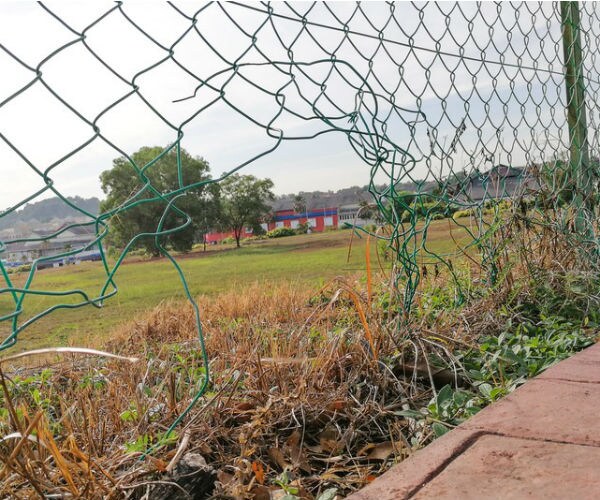 broken chain link fence border wall