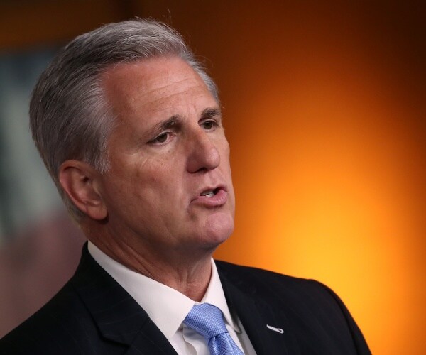 mccarthy in a suit and light blue tie