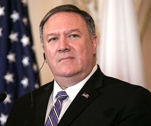 mike pompeo listens to a translation in japan