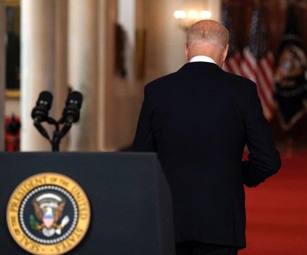 joe biden departs after delivering remarks at podium with presidential seal