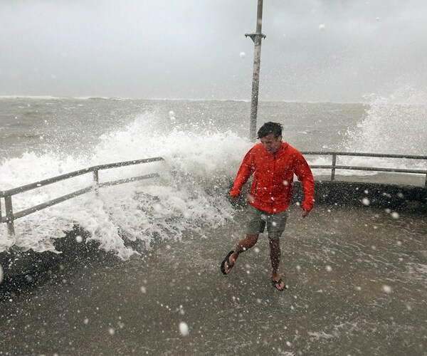 A wave crashes over a jetty at Jupiter, Florida