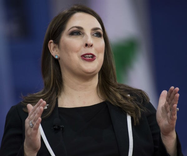 ronna mcdaniel is shown gesturing with her hands as she speaks to an audience