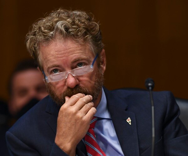 sen. rand paul listens wearing reading glasses