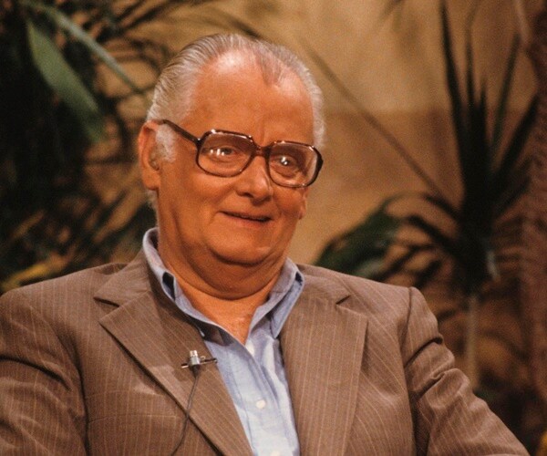 art carney sits and smiles during an interview