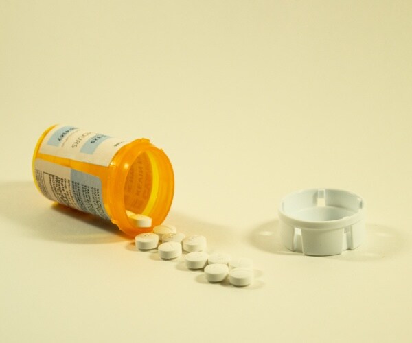 spilled bottle of opioid pills