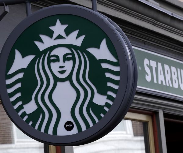 a starbucks coffee shop in harvard square in cambridge, mass.