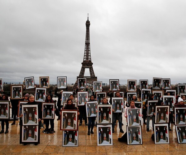 French Activists Use Macron Portraits to Urge Climate Action