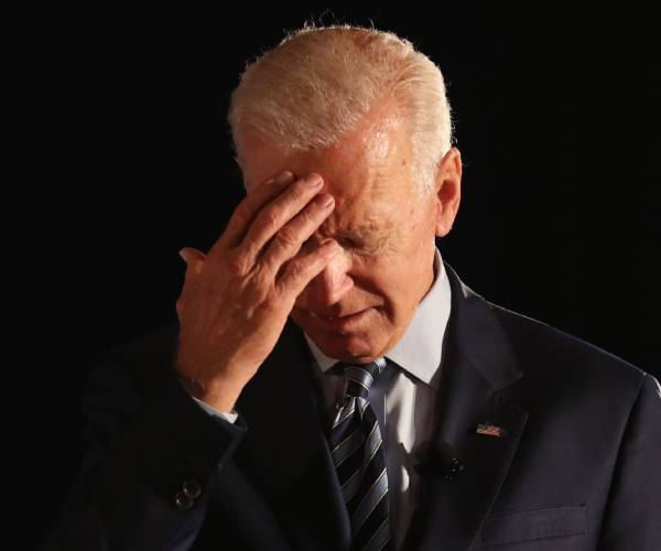 joe biden puts his face to his forehead
