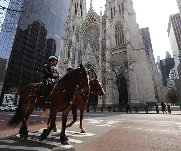 mounted police officers walk past st. patrick's cathedral