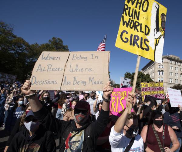 rallygoers carry signs