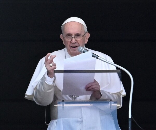 Pope Francis delivers the Sunday Angelus prayer from the window of his study.
