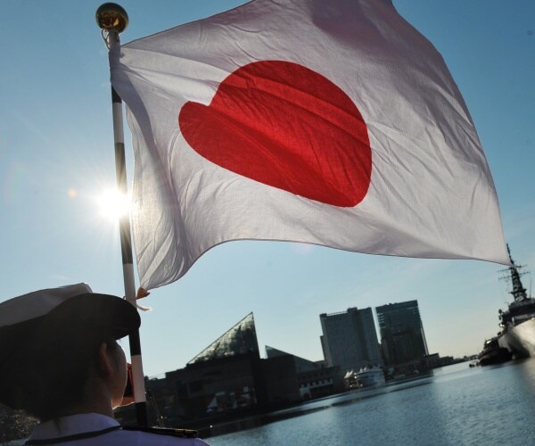 japanese flag flies in the sky