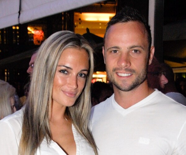 steenkamp and pistorius in white shirts smiling for a picture