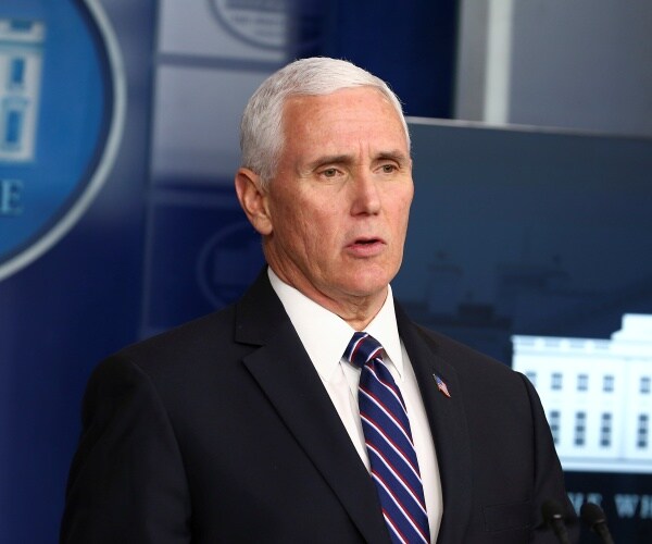 pence in a suit and blue striped tie
