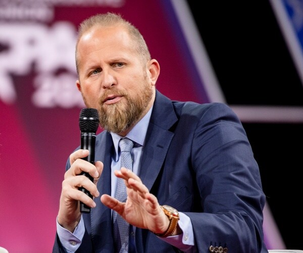 brad parscale sits on a stage at cpac and speaks