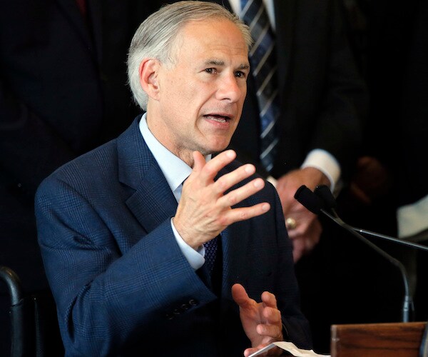 greg abbott gestures and speaks during a news conference