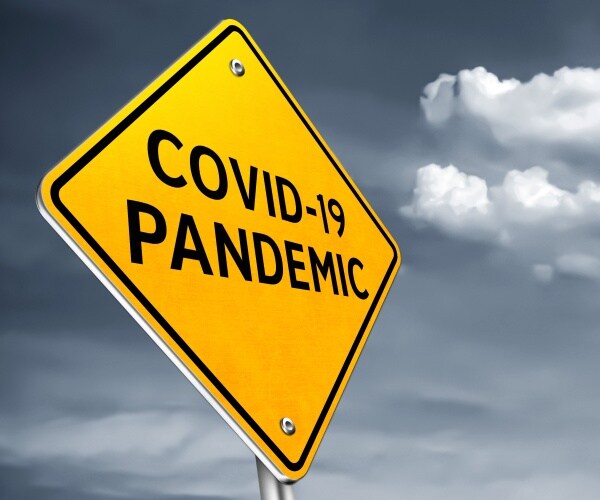 yellow road sign saying "COVID-19 Pandemic"