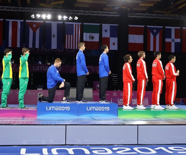 race imboden is kneeling while other competitors are standing