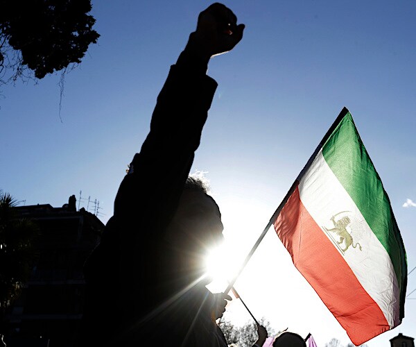 iranian protesters wave a flag of the country