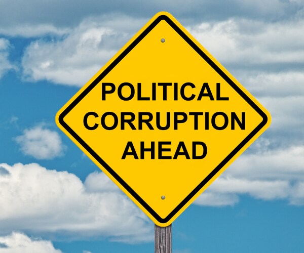 a road sign reading political corruption ahead