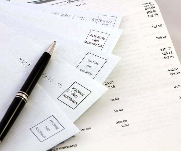 a pen on tope of a stack of bills