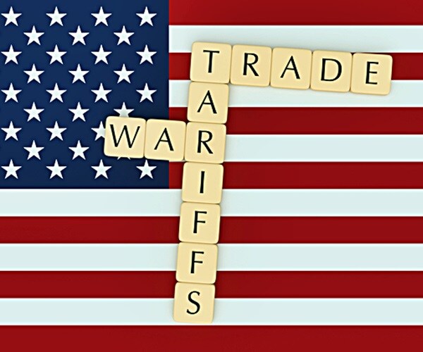 letter tiles tariffs and trade war on us flag

