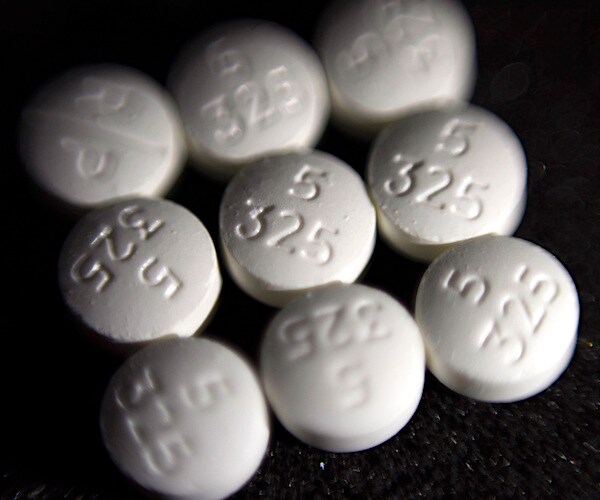 pills are lined up in a square on a dark table
