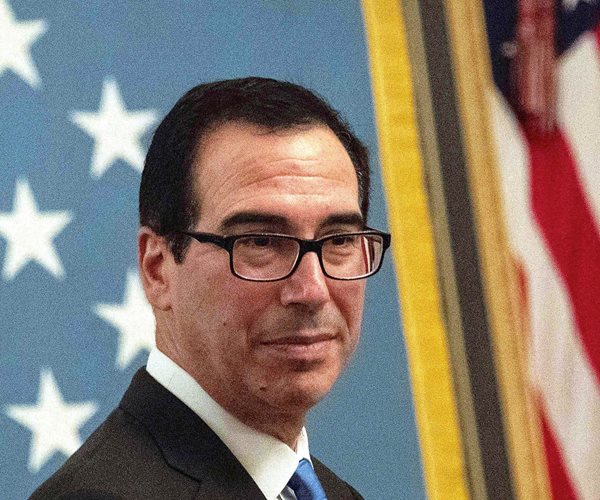 treasury secretary steven mnuchin poses in front of flags