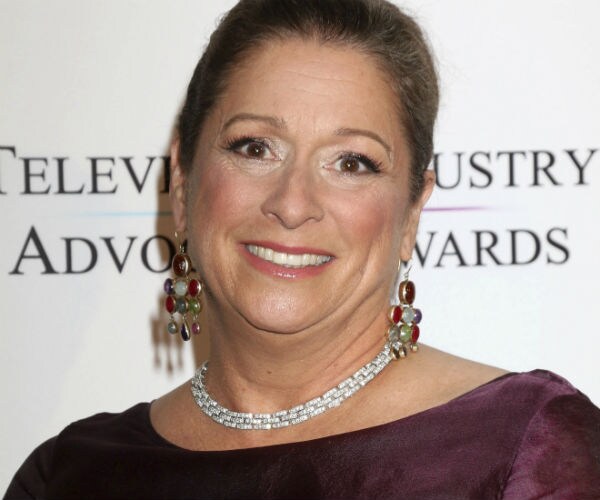 abigail disney is seen wearing multi-colored earrings, diamond necklace and a wine evening dress